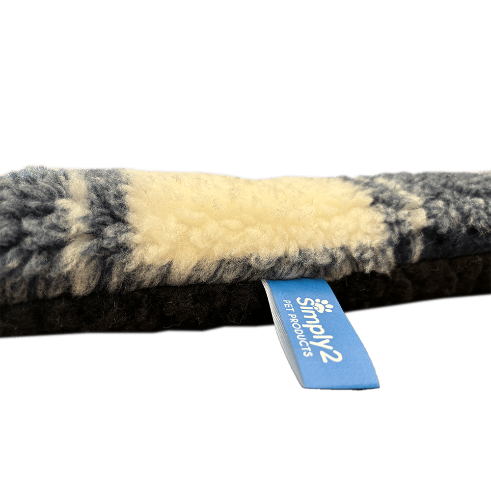 close up side view of blue white tartan snug'em showing thickness and tag