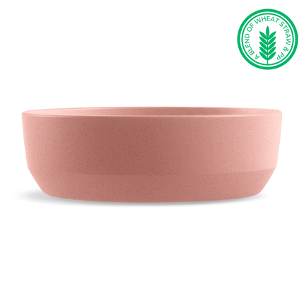 Pink bowl with a green label indicating a blend of wheat straw on a white background
