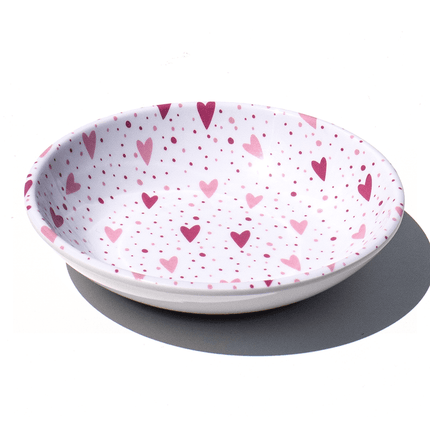 white saucer with pink hearts
