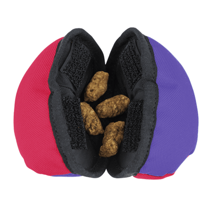 Pink, purple and black mesh pouch with dog treats on a white background
